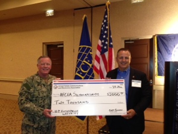 TAMPA-ST. PETERSBURG-In July, Glen Sharlun, Department of Defense director, HP Enterprise Security Products, presents a check for AFCEA scholarships to Capt. Gerry Slevin, USN, chapter president.